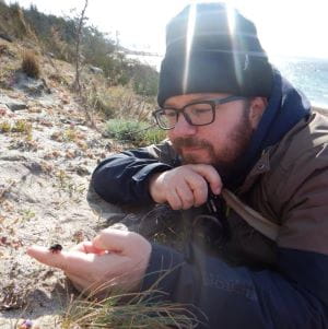 Dr. Cory Sheffield holding a bee at Savary Island