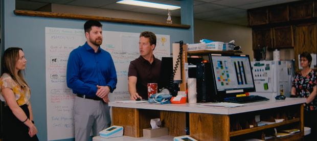 Dr. Harrison discussing with the primary care team at the daily huddle