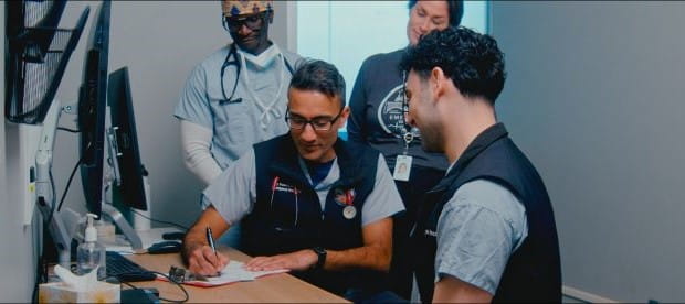 Dr. Kapur discussing with colleagues