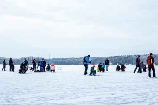 People ice fishing on a frozen lake in Saskatchewan