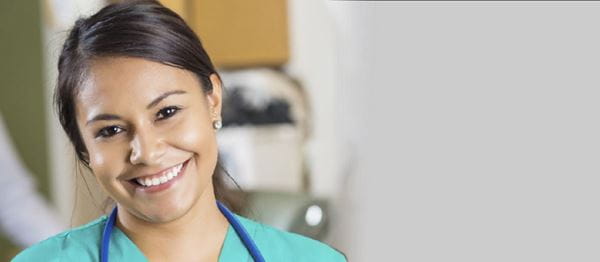 Young female nurse in green scrubs