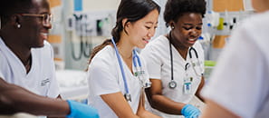 Three nursing students, one male and two female, working in a hospital.