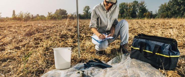 Photo of a Qualified Person analyzing land with inspection tools