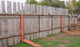 Fence with angle iron on support legs